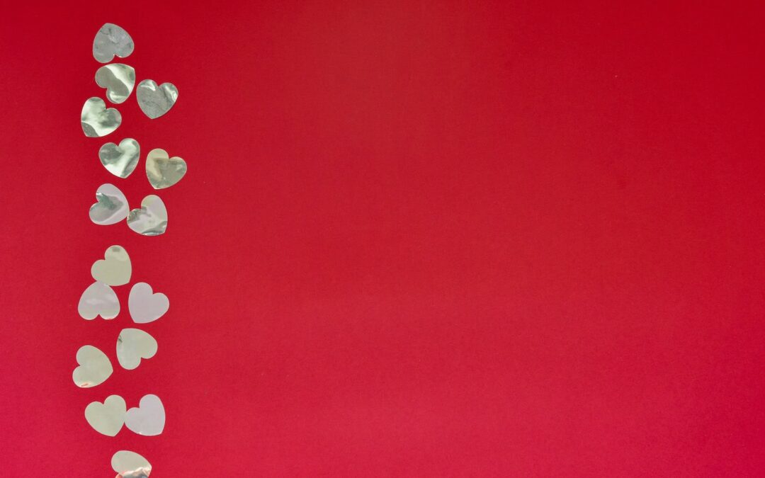 Hearts of paper on red textured background. San Valentine day concept.