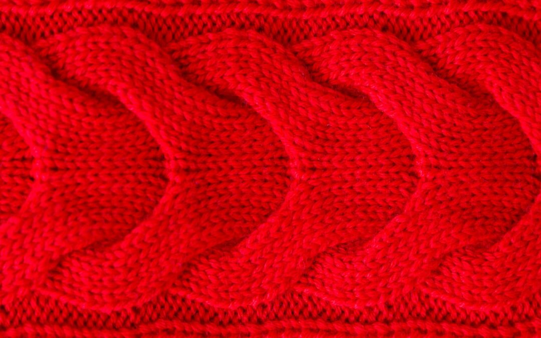 Red knitted winter sweater Background, red texture